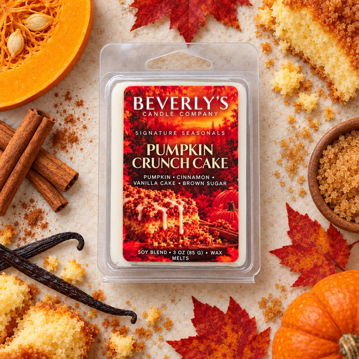Pumpkin Crunch Cake Wax Melts 3 oz, clamshell pack lying flat with a halved pumpkin, cinnamon sticks, vanilla pods, crumb cake pieces, maple leaves and a bowl of brown sugar