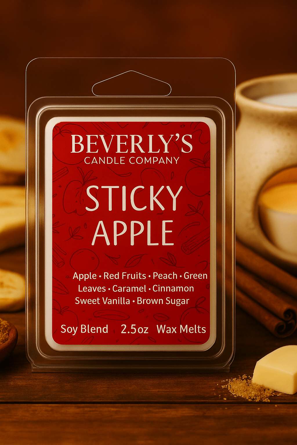 Beverly's Candle Company Sticky Apple wax melt packaging with a lit candle, apple and spices on a wooden surface.
